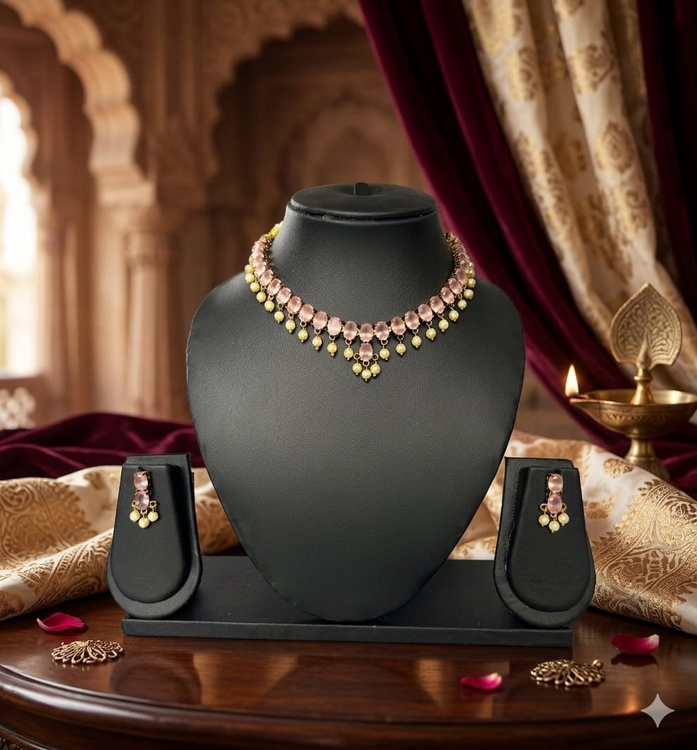 Necklace and earrings on a black mannequin bust with a decorative background