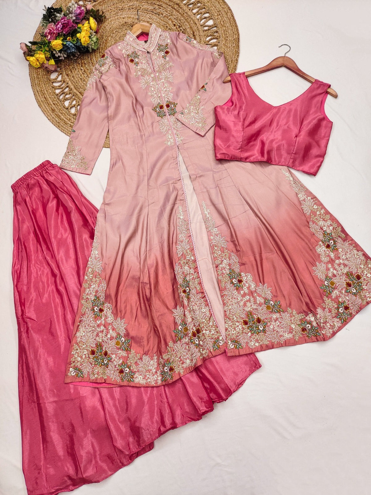 Pink embroidered traditional outfit with a blouse on a white background